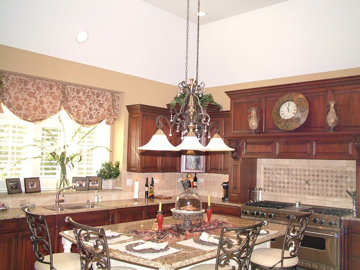 A kitchen with a table and chairs and a clock on the wall