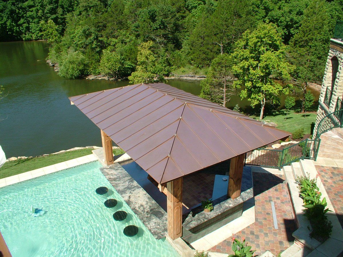 An aerial view of a swimming pool with a gazebo over it