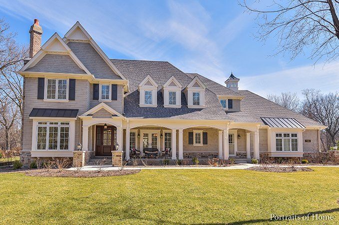 A large house with a lot of windows and a porch