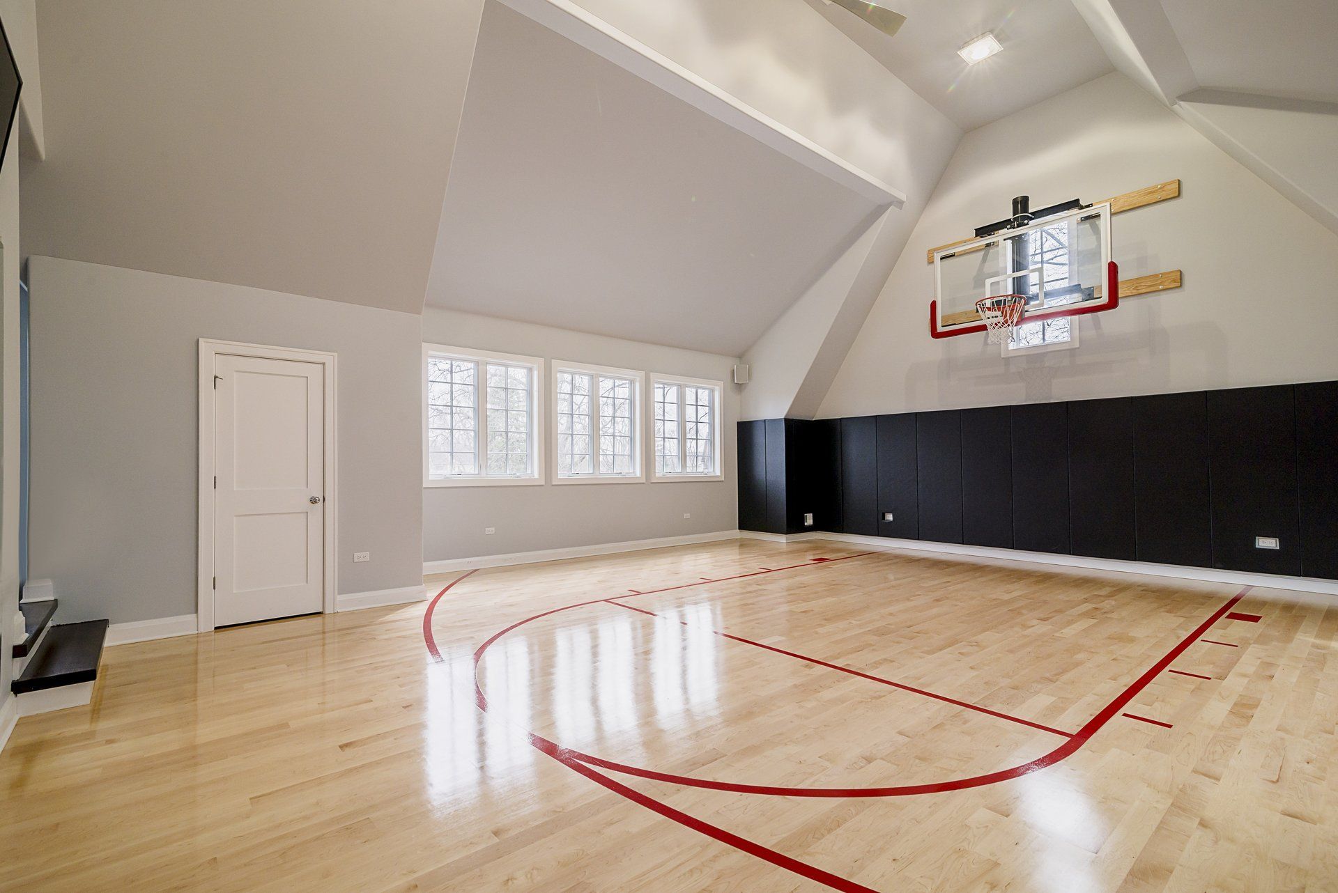 An empty basketball court with a hoop on the wall