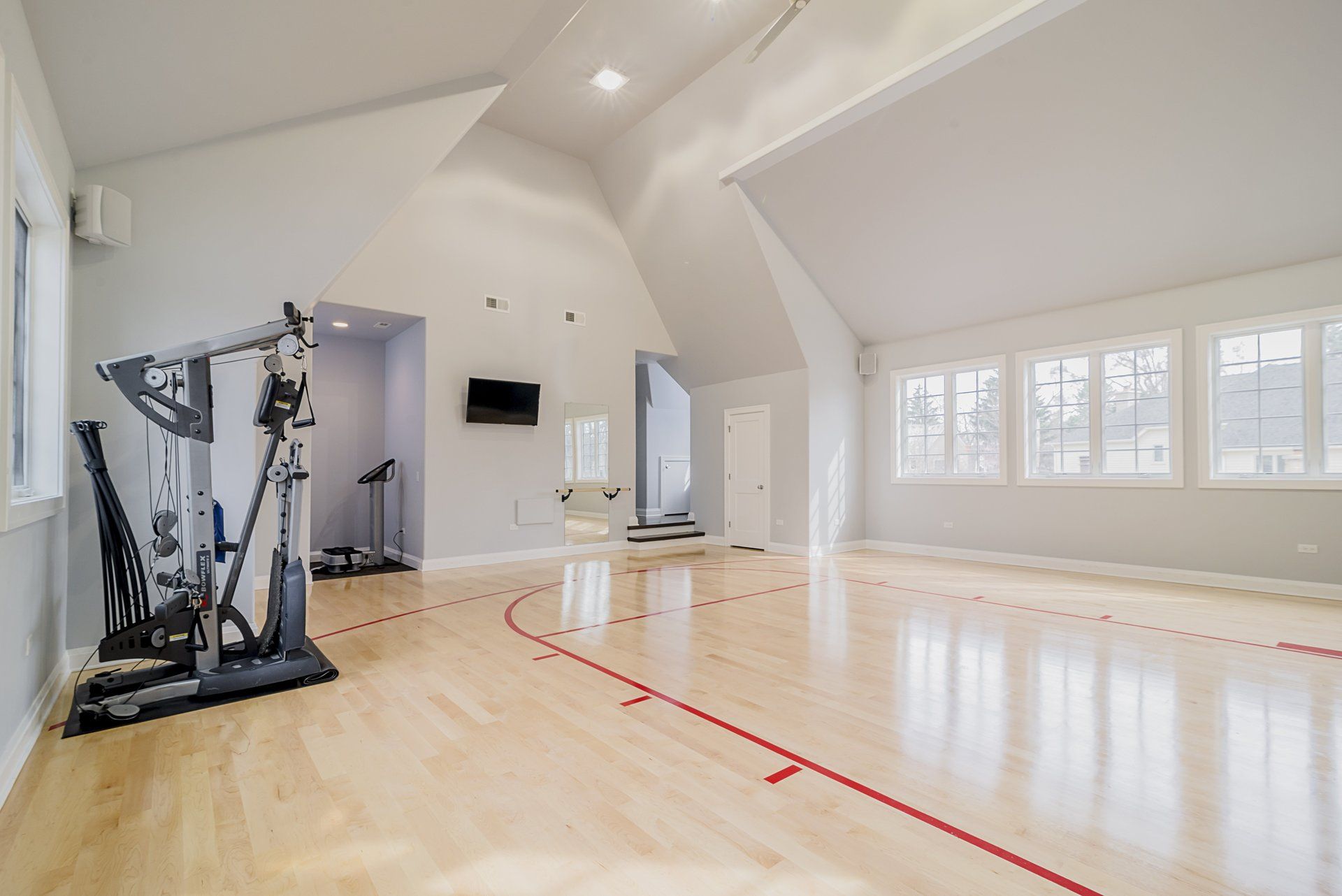There is a basketball court in the middle of the room.