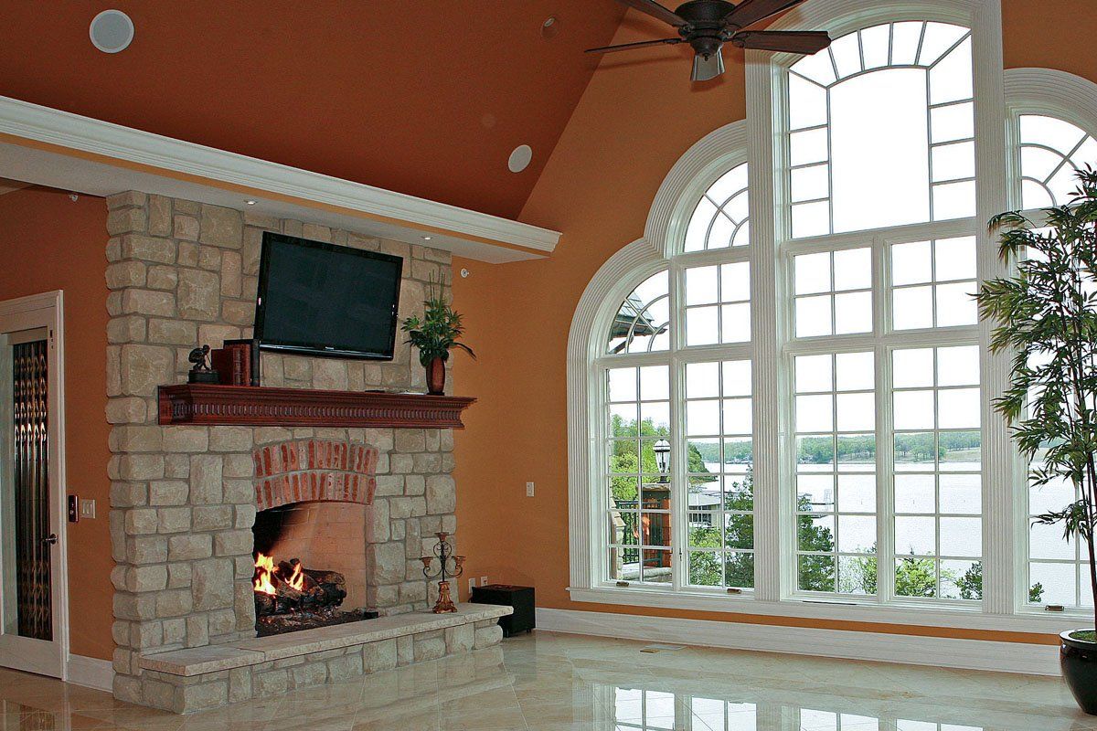 A living room with a fireplace and a flat screen tv