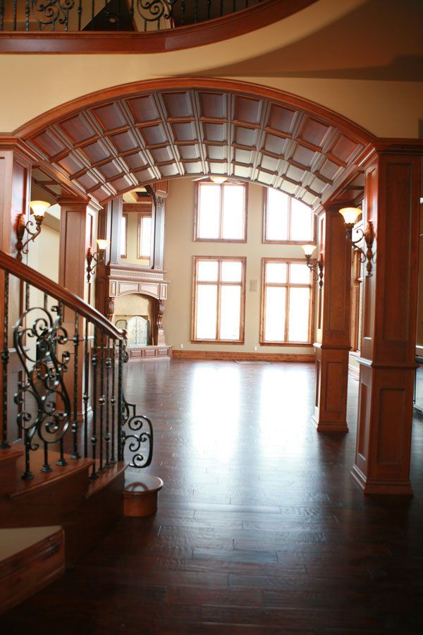 A hallway with a staircase and arched ceiling