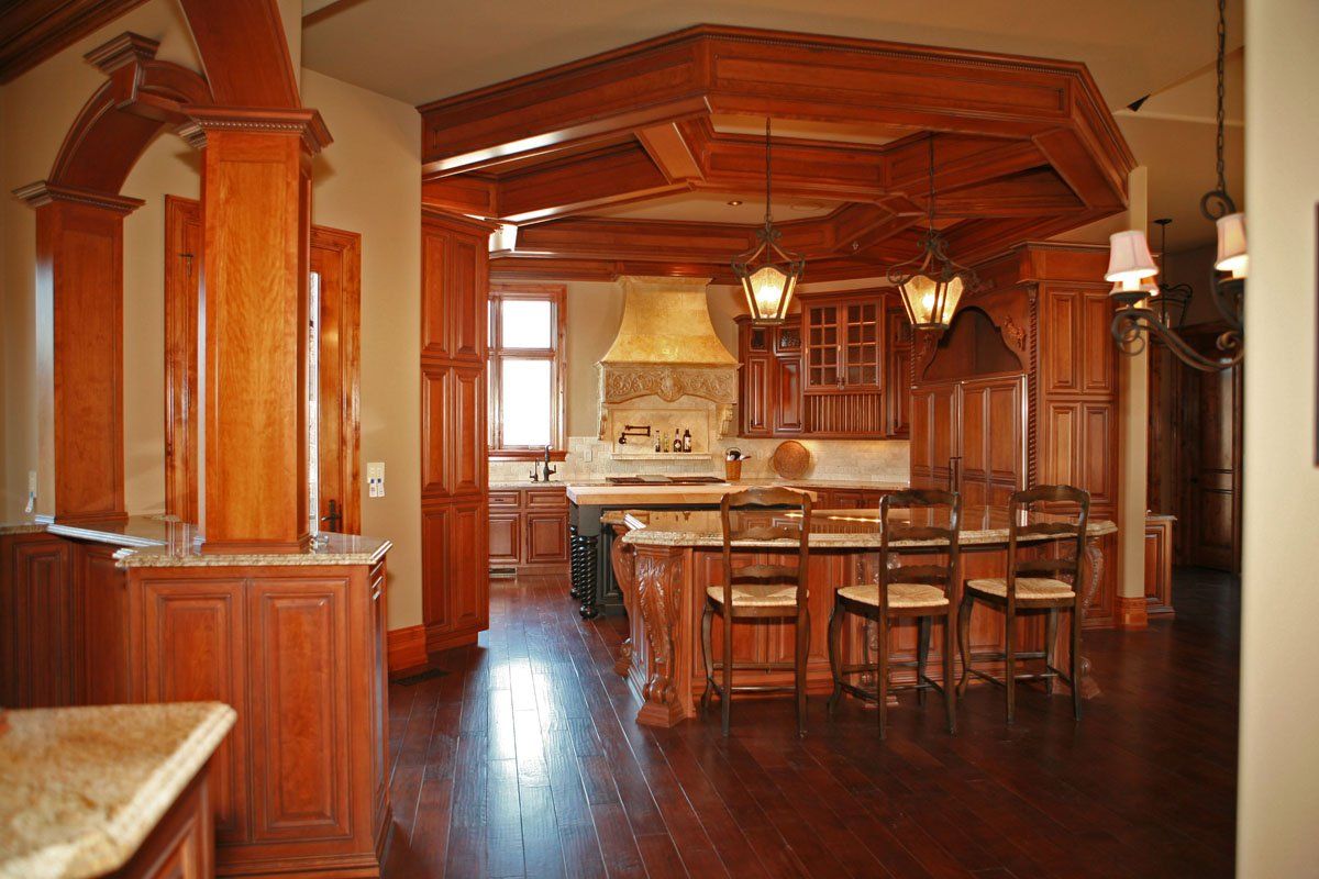 A kitchen with wooden cabinets and a large island