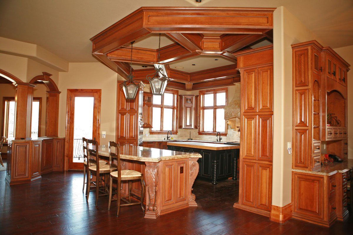 A kitchen with wooden cabinets and a large island