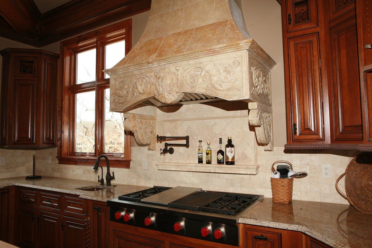 A kitchen with wooden cabinets and a stove top oven