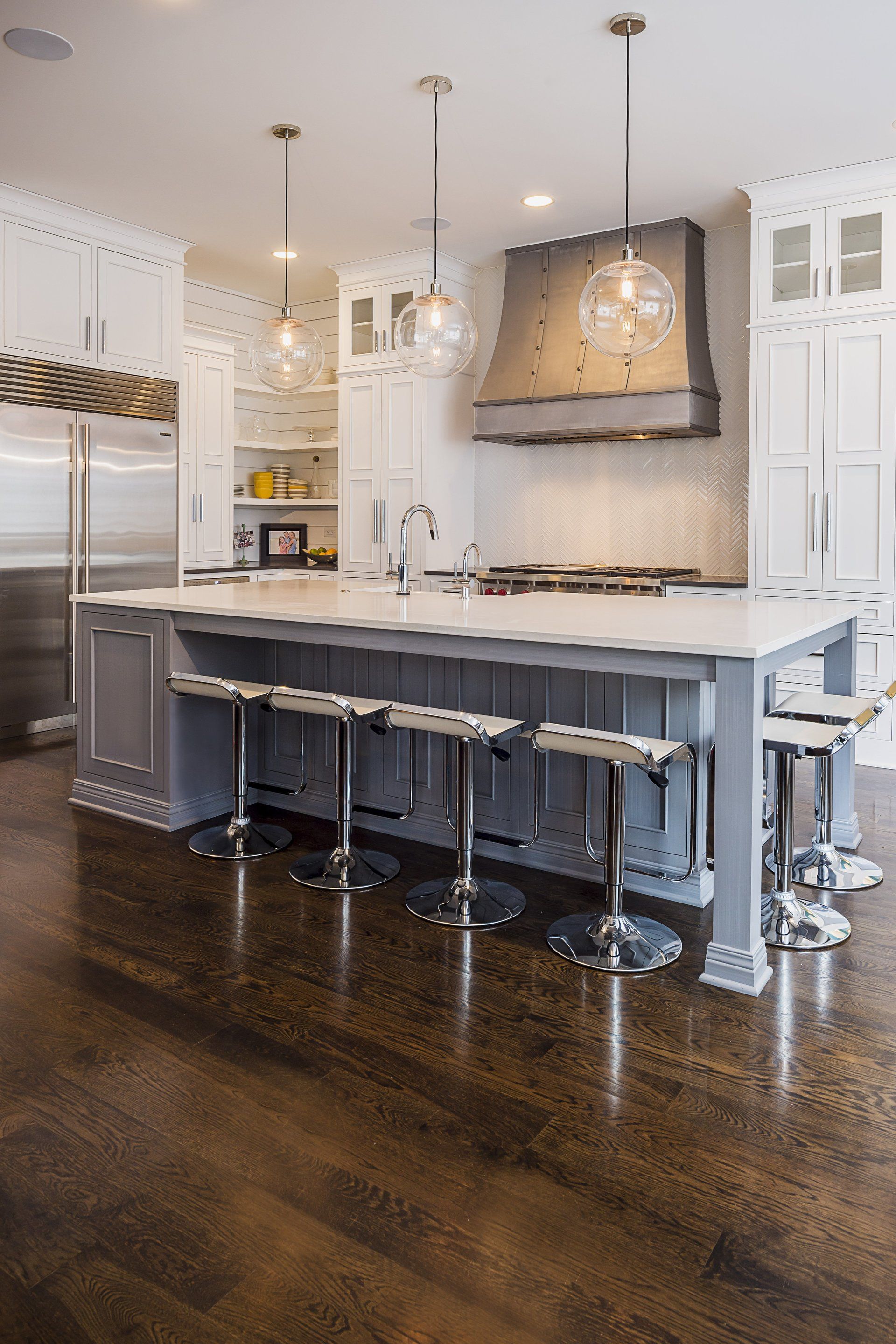A kitchen with a large island and stools