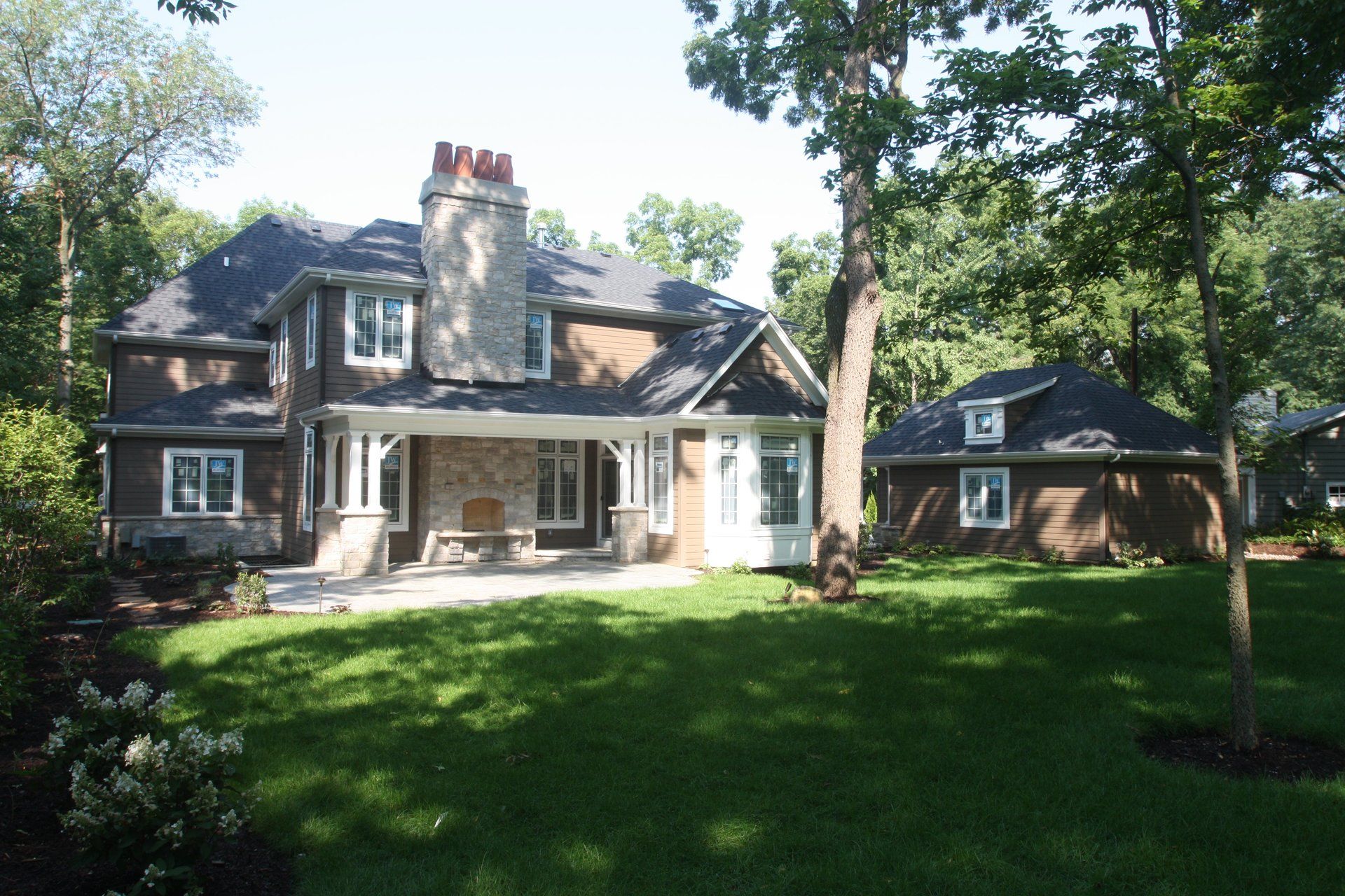 A large brick house with a porch and a chimney