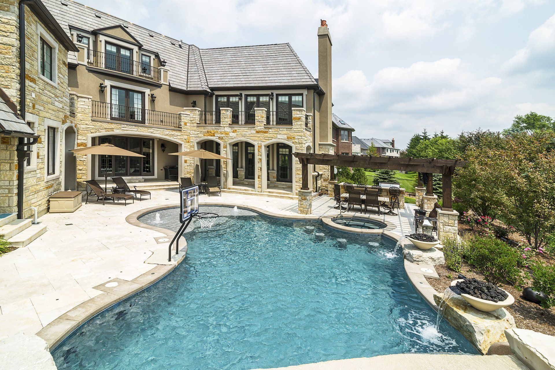 A large house with a large swimming pool in front of it