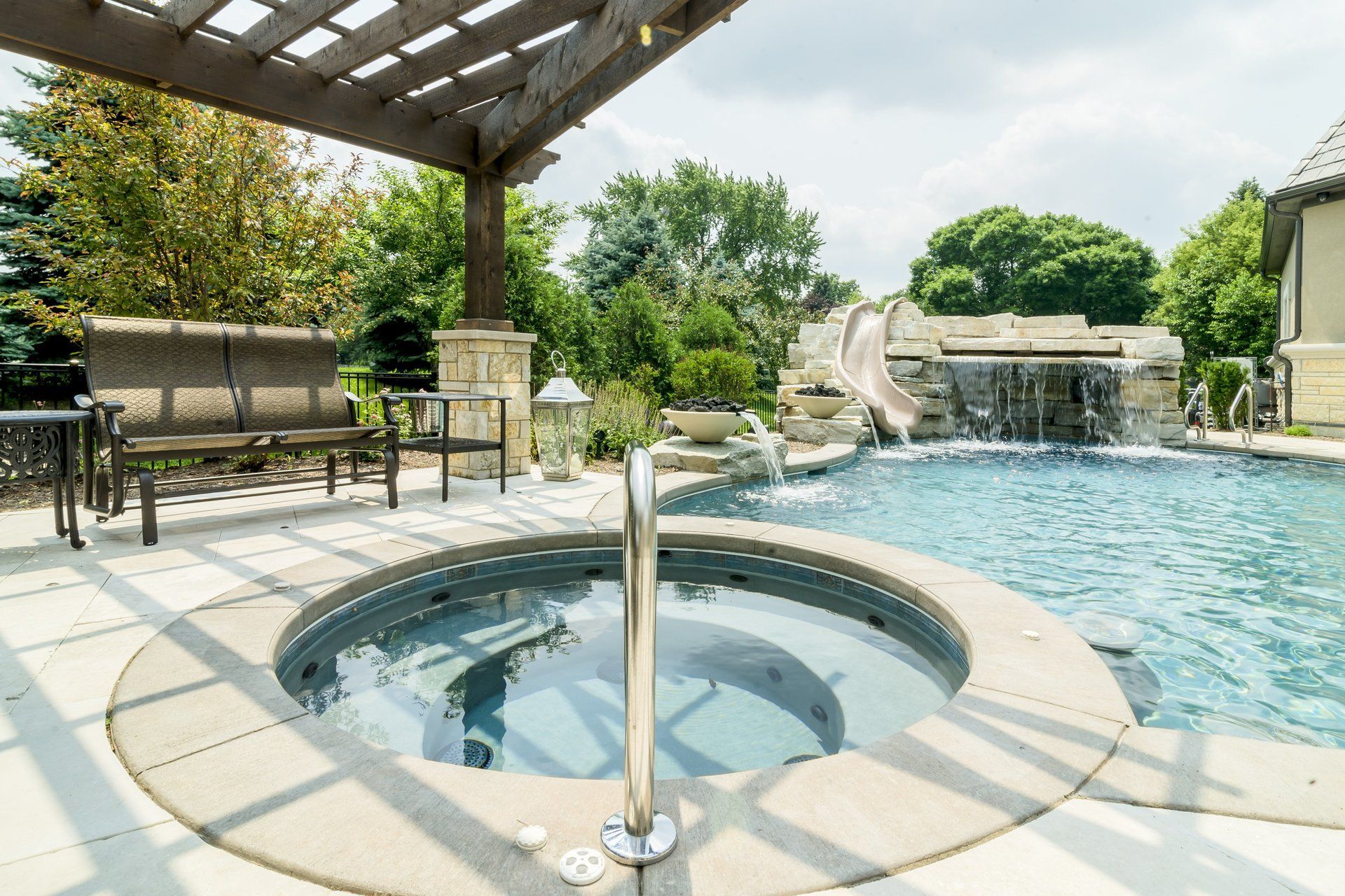There is a hot tub in the middle of the pool.