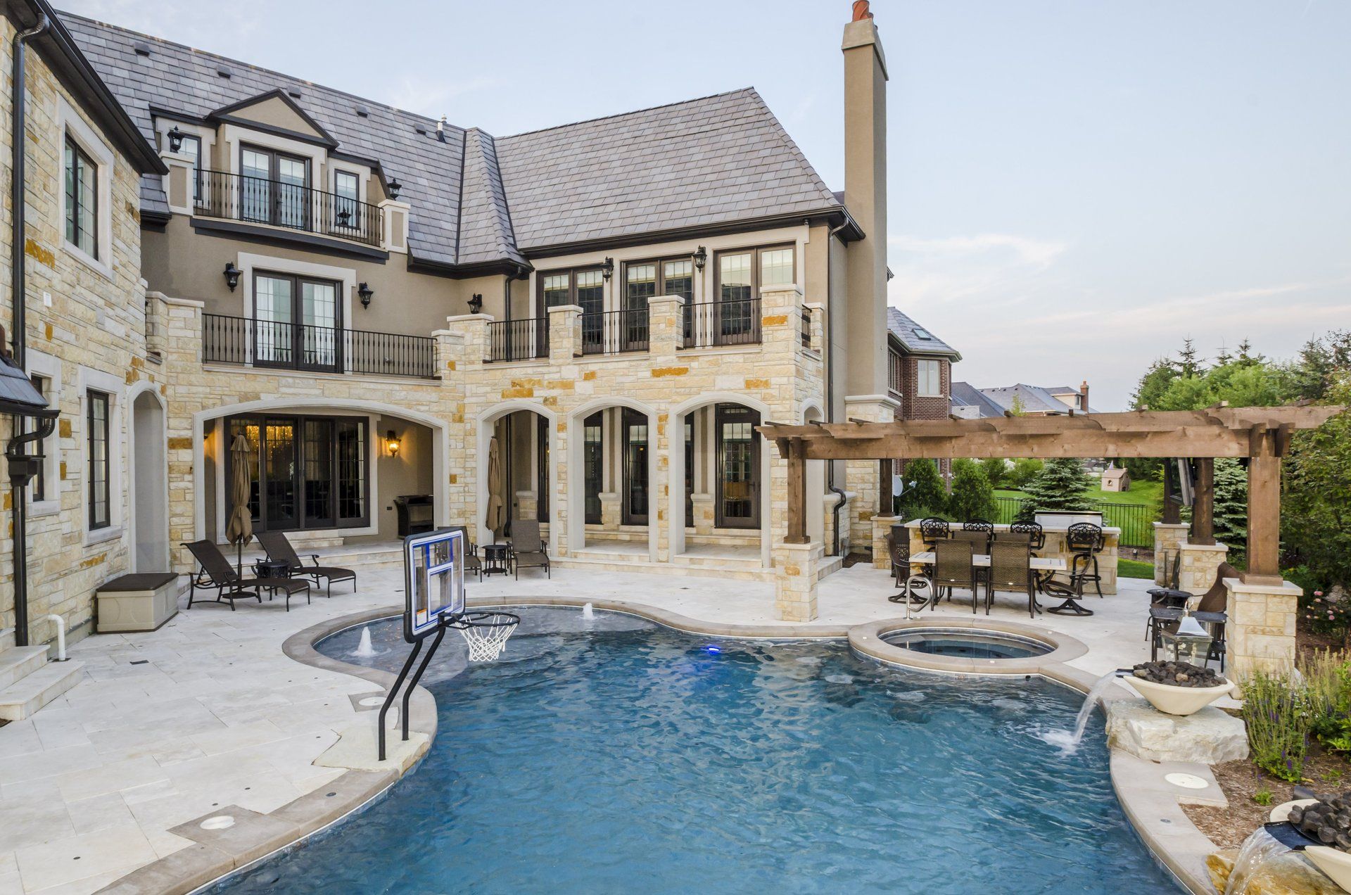 A large house with a large swimming pool in front of it.