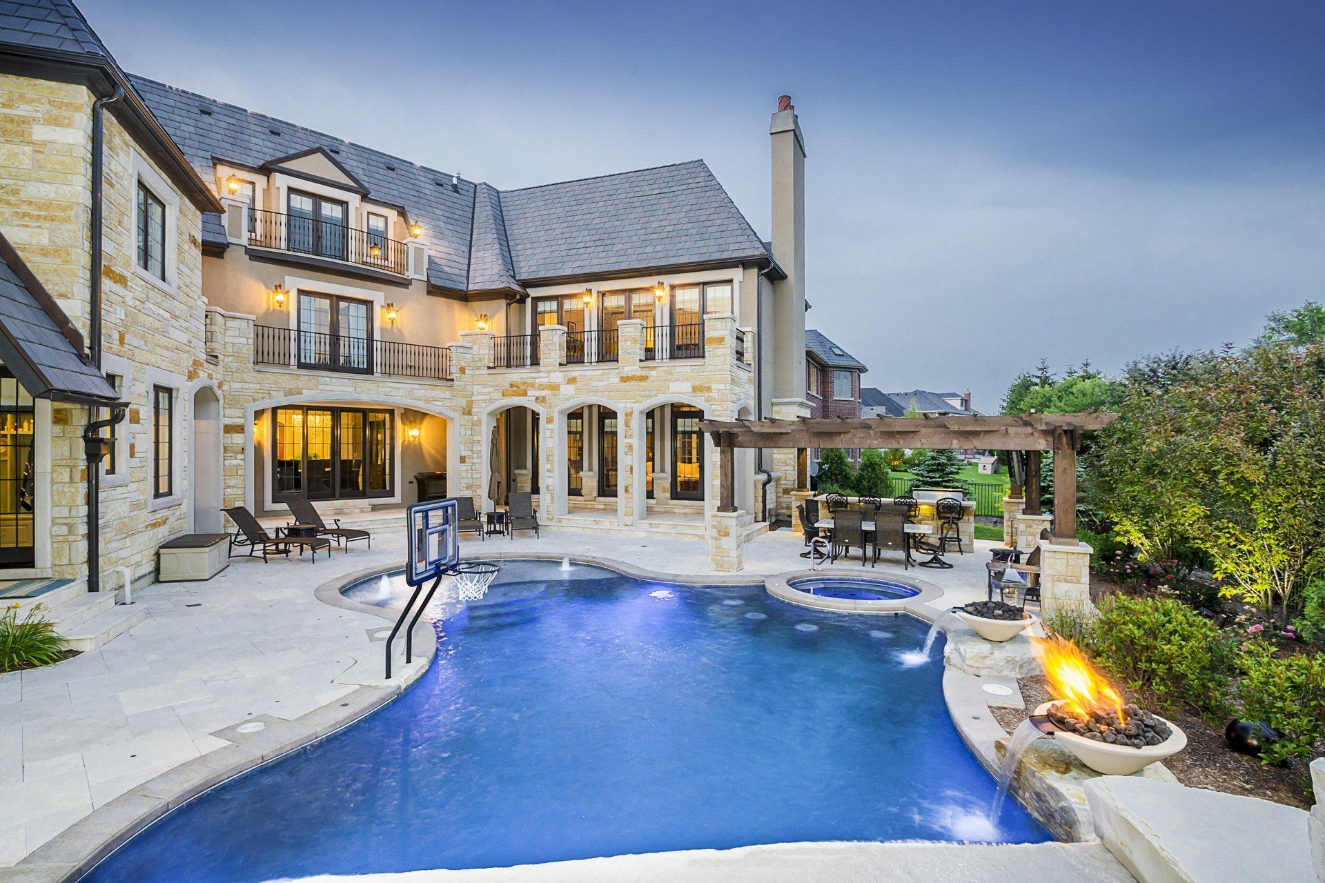 A large house with a large swimming pool in front of it.