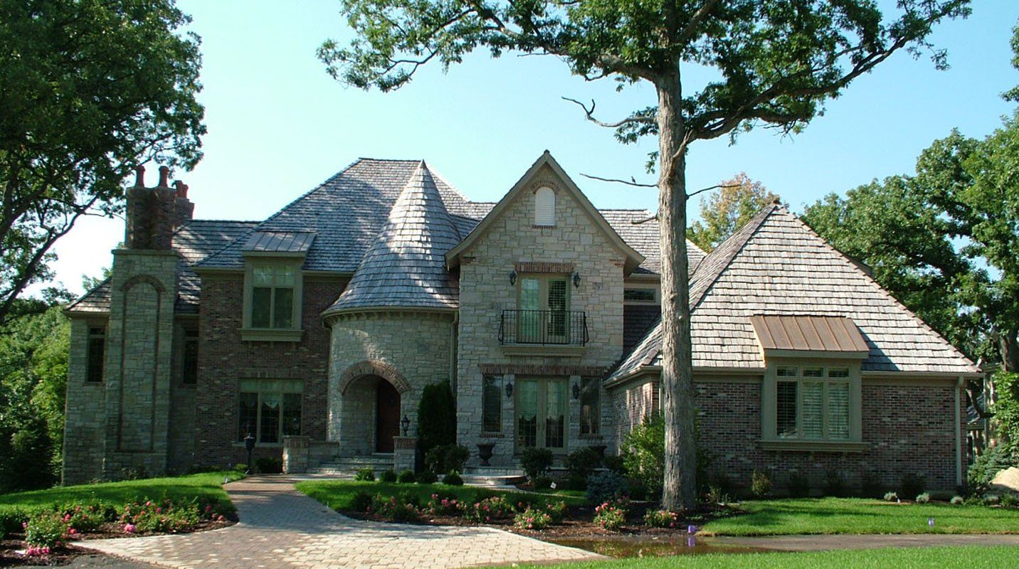 A large house with a tree in front of it
