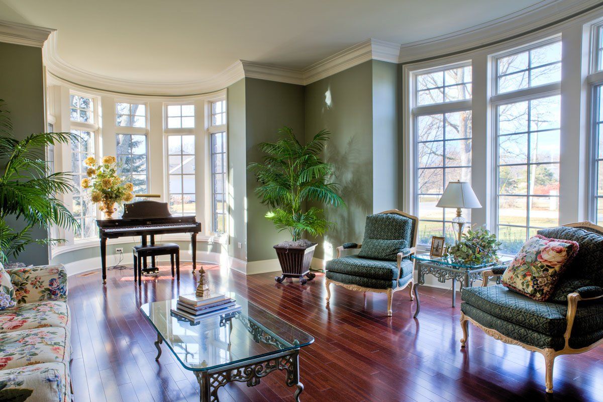 A living room filled with furniture and a piano.