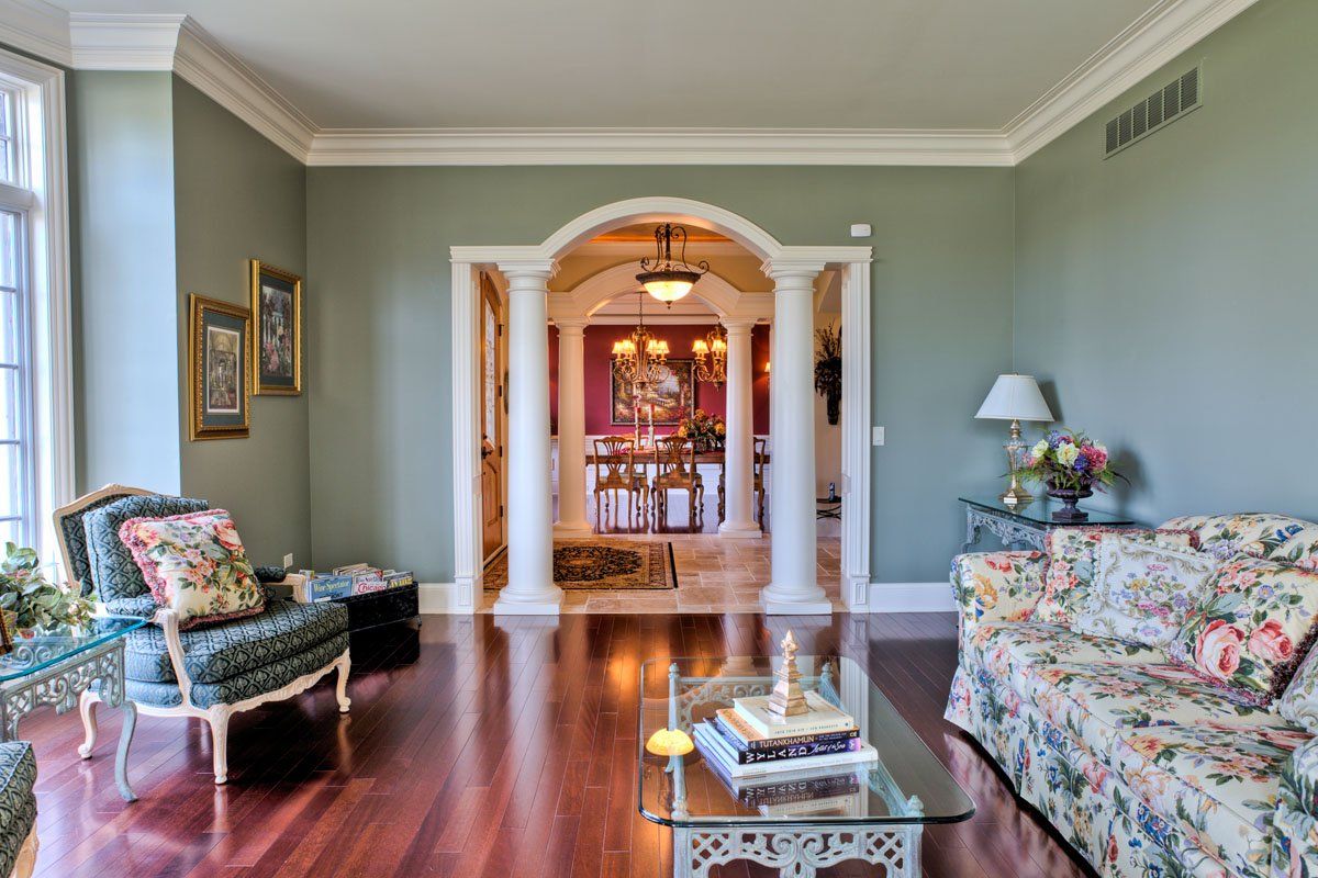 A living room with a couch , chairs , and a coffee table.