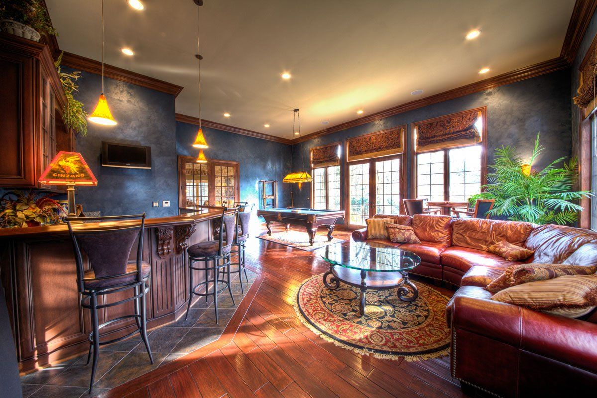 A living room filled with furniture and a pool table.