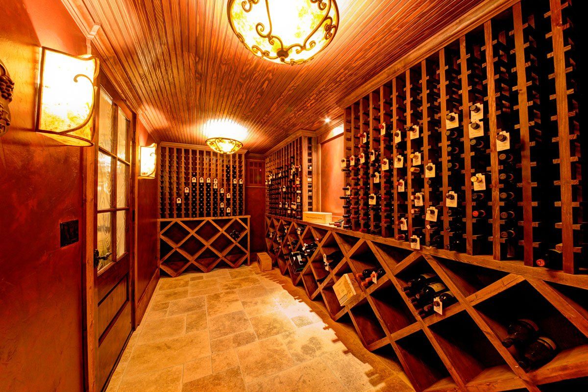 A large wine cellar filled with lots of bottles of wine.