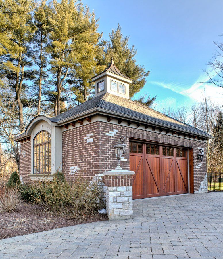 A brick building with a wooden garage door