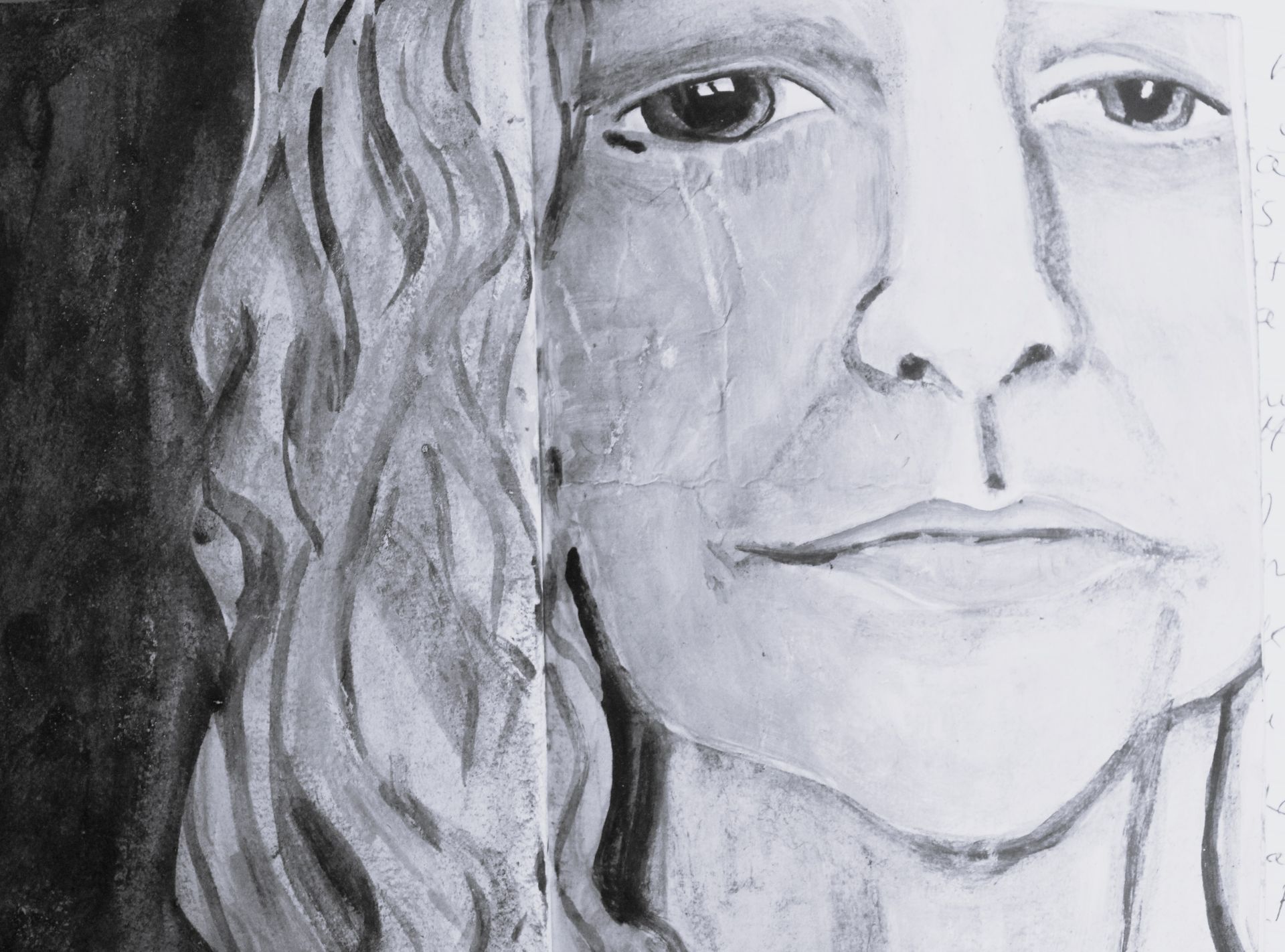 Black and white portrait of a person with long wavy hair, looking somber, with tears streaming down their face.