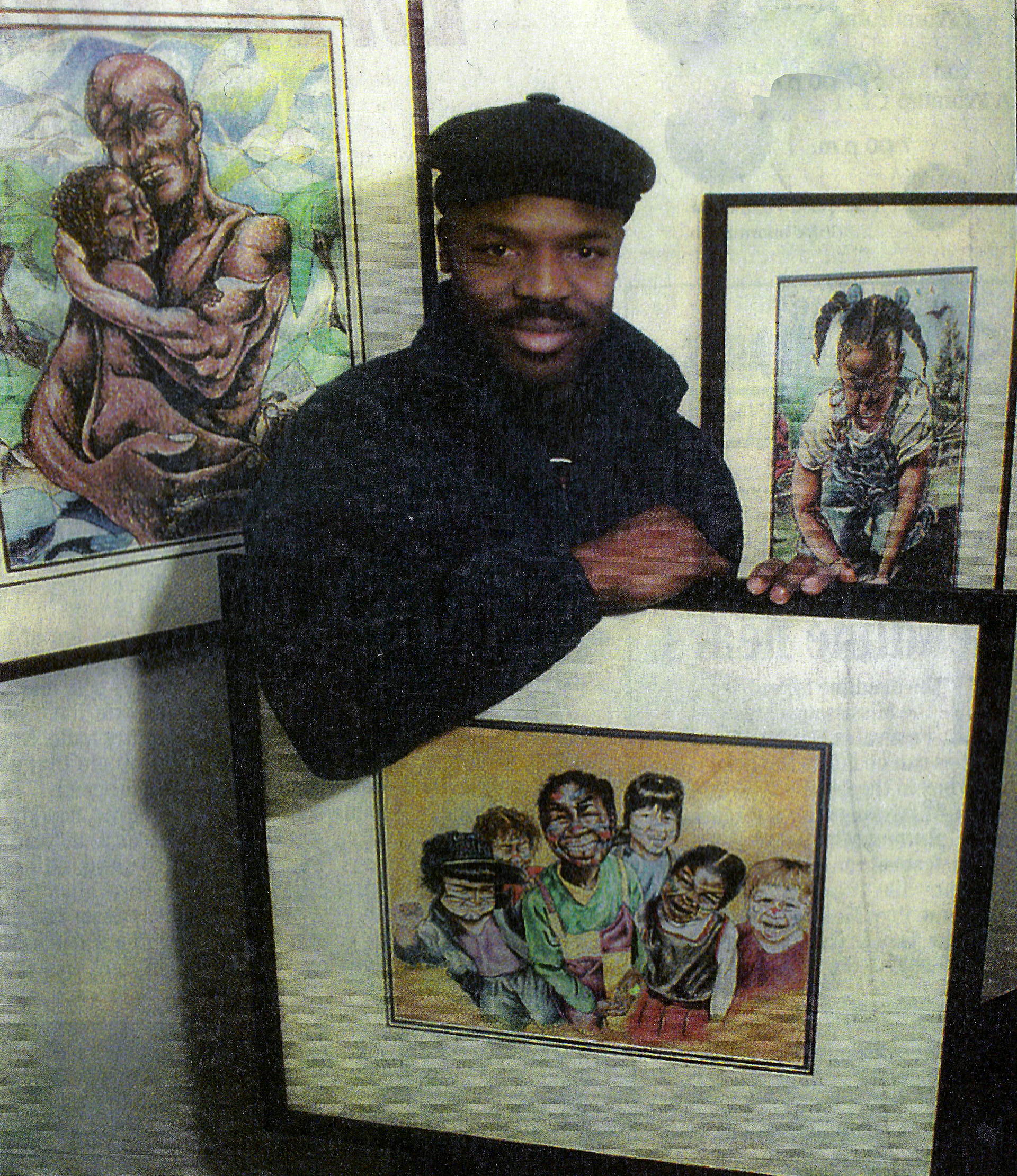 A man is holding a framed picture of a family