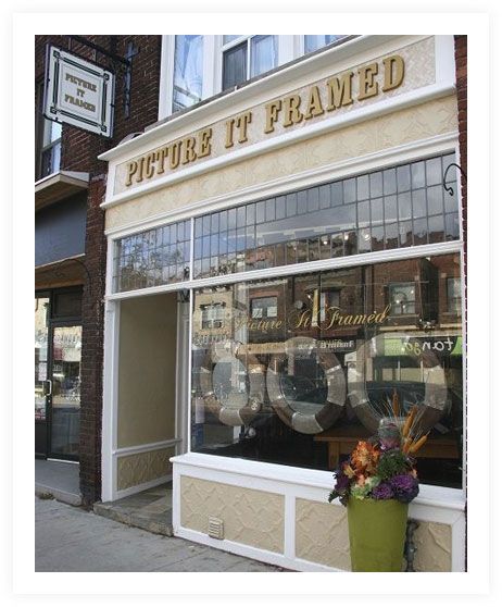 Picture it framed store front with flowers in front of it