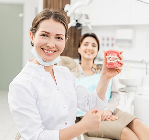 Female Dentist with Denture | Granger, IN | Bittersweet Road Family Dentists
