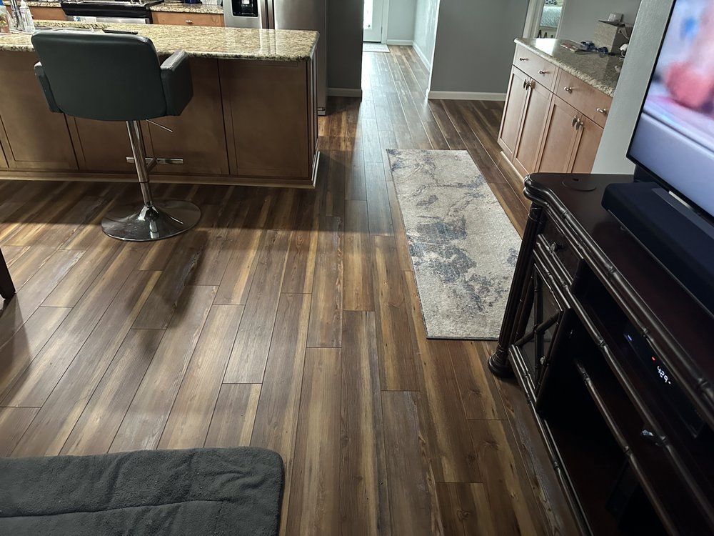 A living room with hardwood floors and a flat screen tv