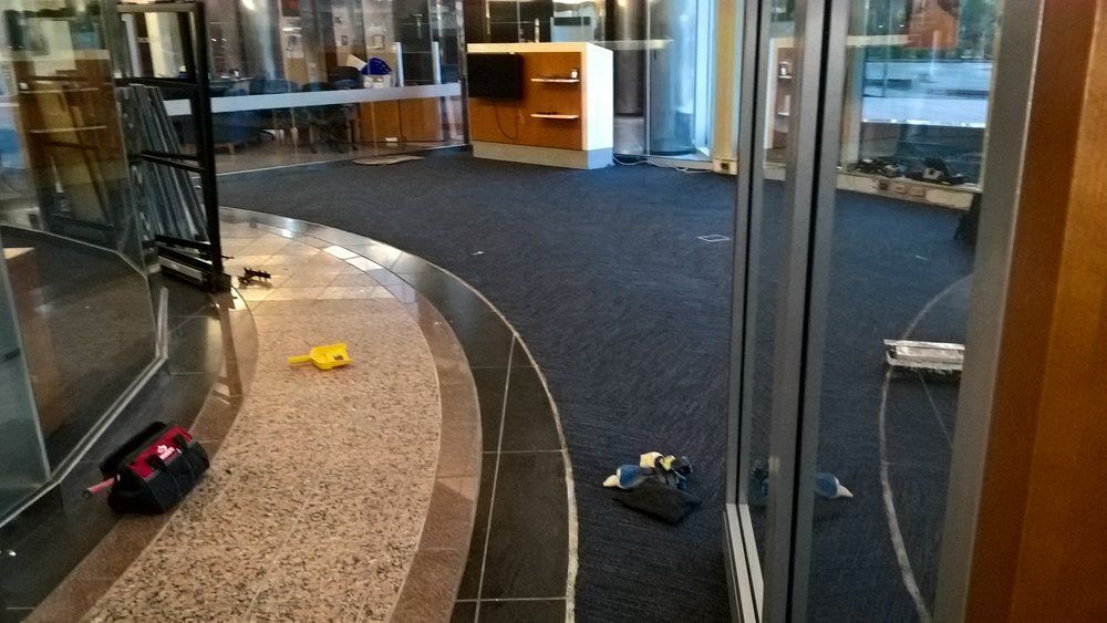 A room with a lot of windows and a carpeted floor