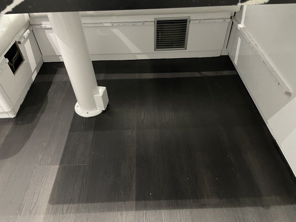 A black and white photo of a room with a pillar