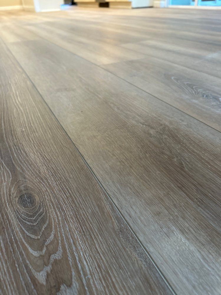 A close up of a wooden floor in a living room.