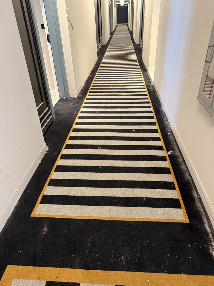 A long hallway with black and white stripes on the floor