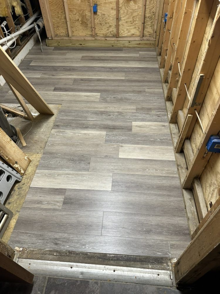 A room with a wooden floor and a wooden wall.