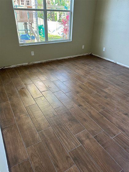 A room with a wooden floor and a window.
