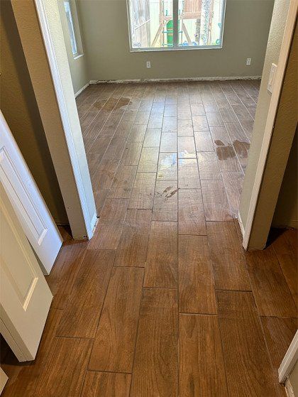 A room with a wooden floor and a sliding glass door.