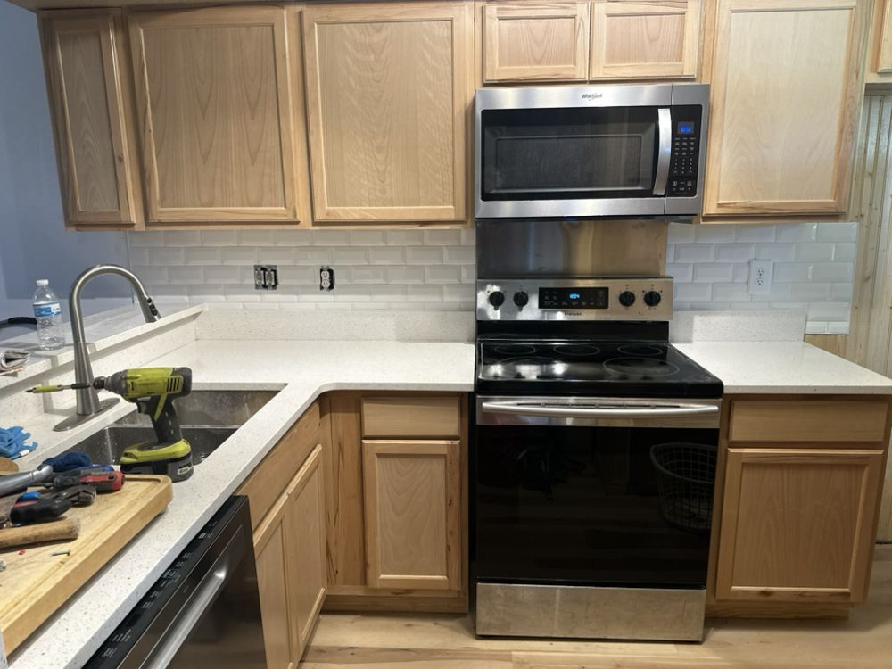 A kitchen with stainless steel appliances and wooden cabinets