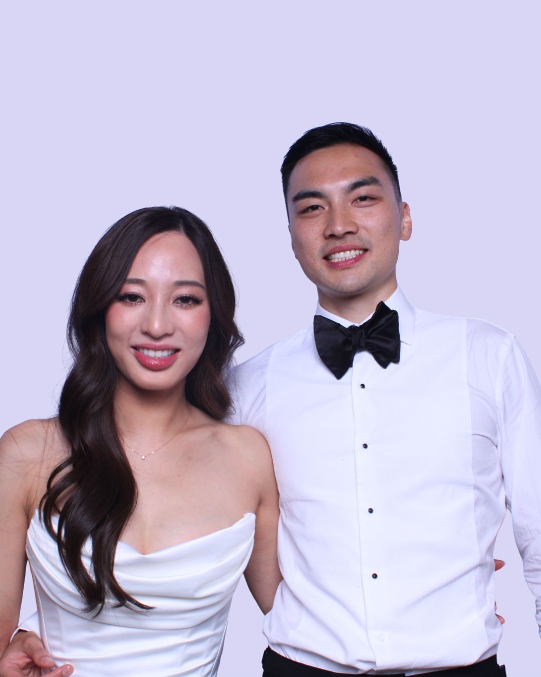 Couple, formal attire, smiling, white dress and shirt, bow tie. BRIDE AND GROOM PHOTO BOOTH.