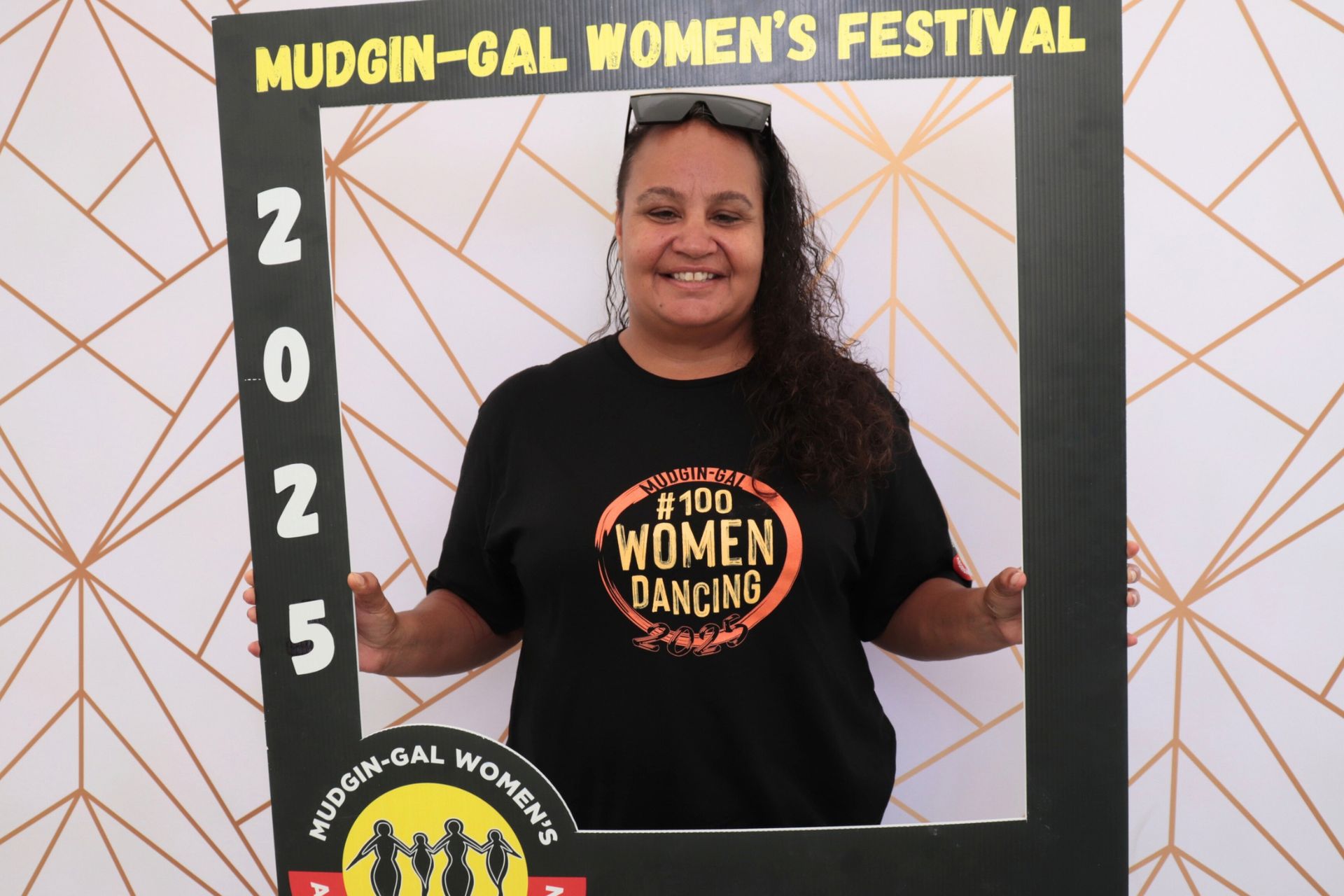 Aboriginal Woman smiling, posing with a frame at the Mudgin-Gal Women's Festival, 2025.