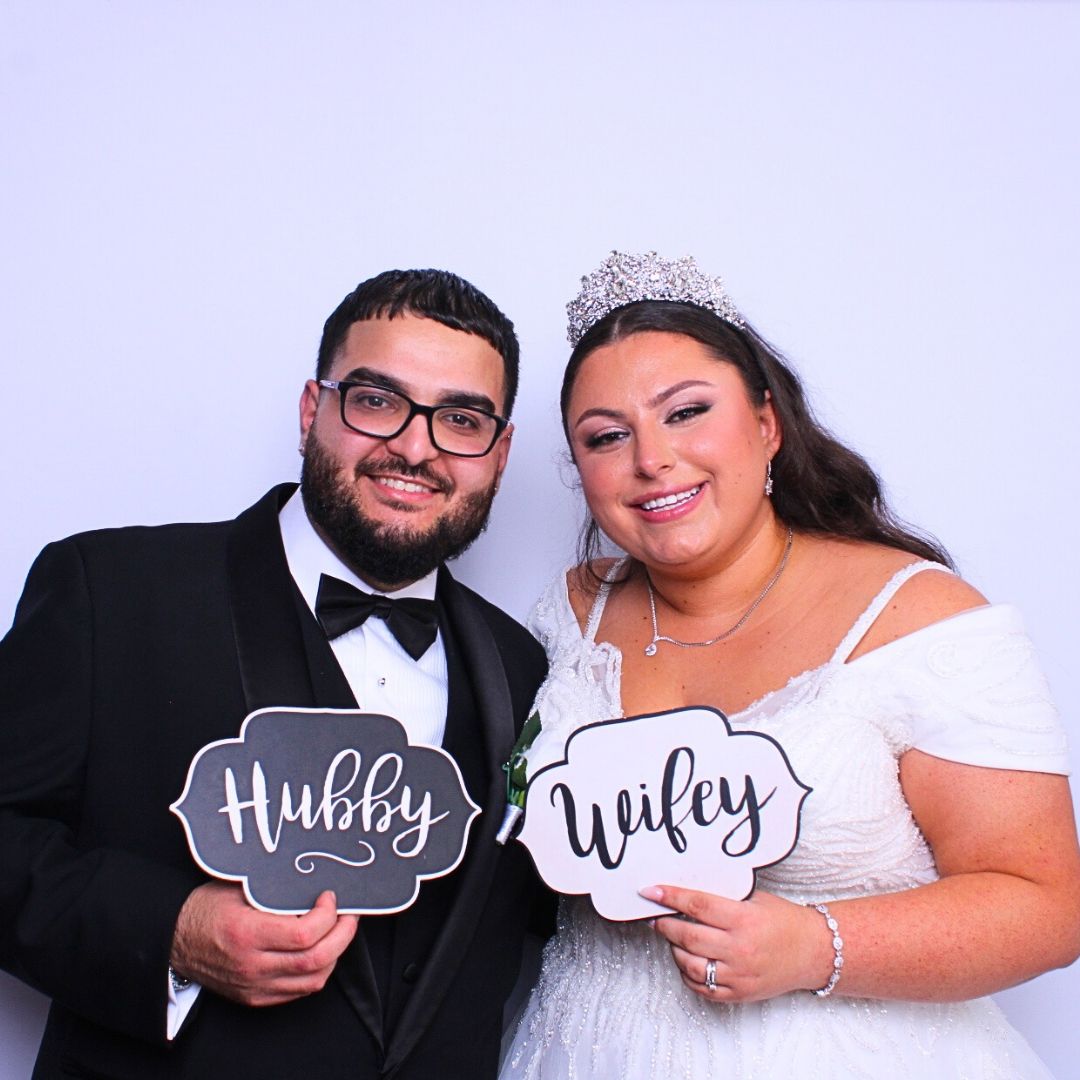 Newlyweds smiling, holding 