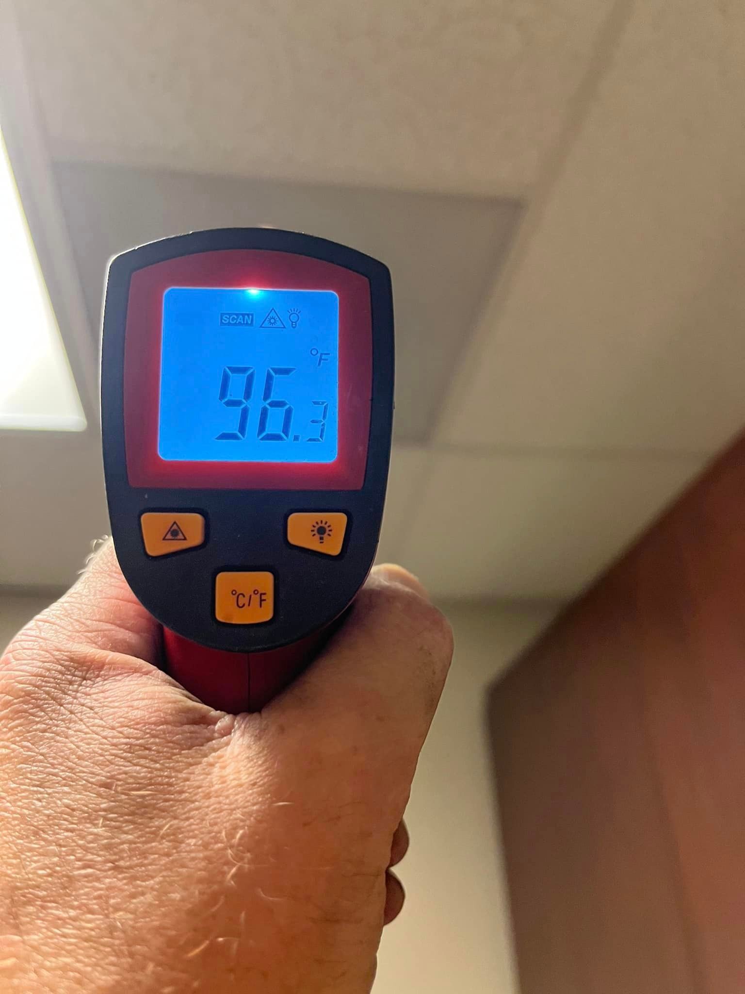 A person is holding a thermometer in their hand.