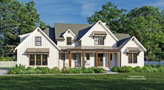 White farmhouse with dark brown accents, front porch, and dormers.