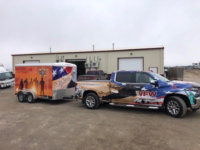 A red elliott crane is lifting a blue surfboard