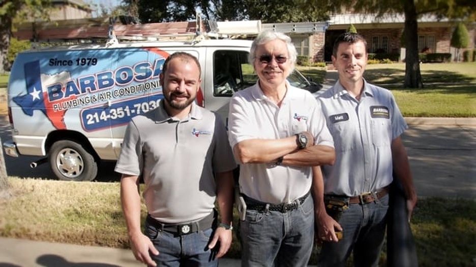 Three men standing in front of a barbosa van