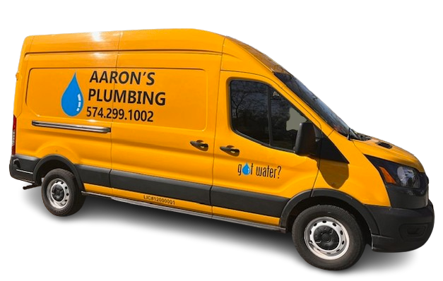 Plumber in blue uniform working under a sink with a toolbox in the foreground.