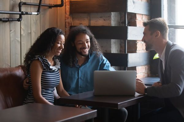 business man talking finance with couple