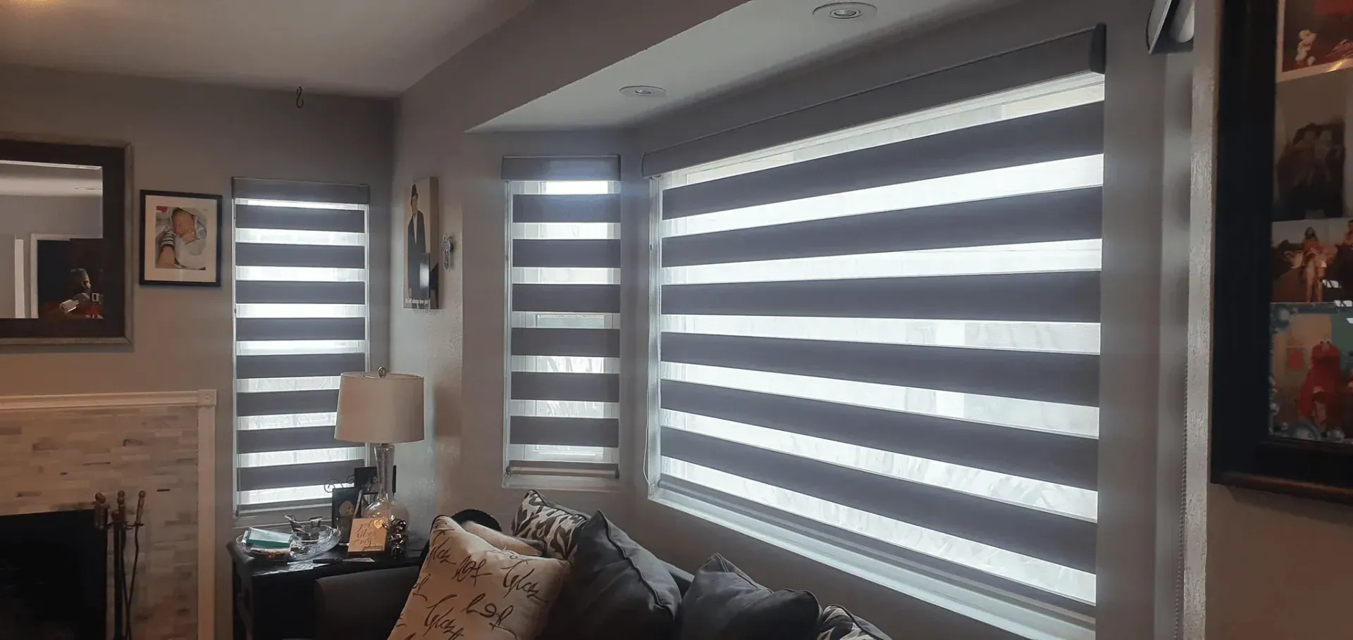 Room with gray and white striped window blinds.