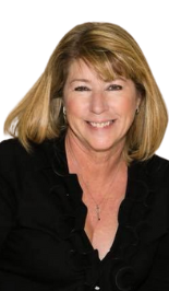 A woman wearing a black shirt and a necklace is smiling for the camera.