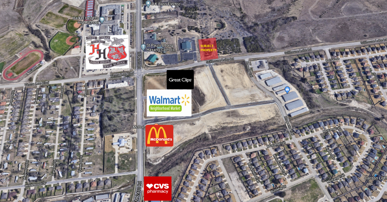 An aerial view of a residential area with a mcdonald 's , walmart , and toys r us.