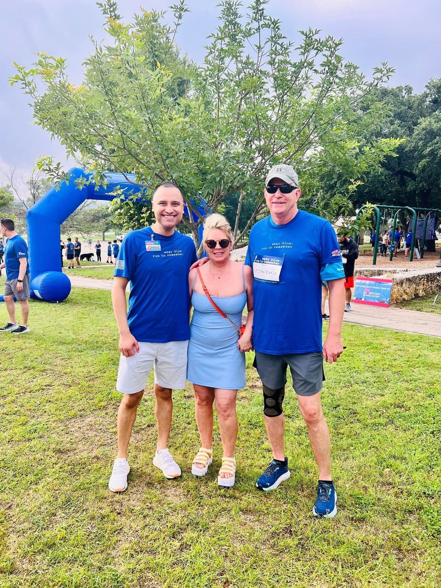 A group of people are posing for a picture in a park.