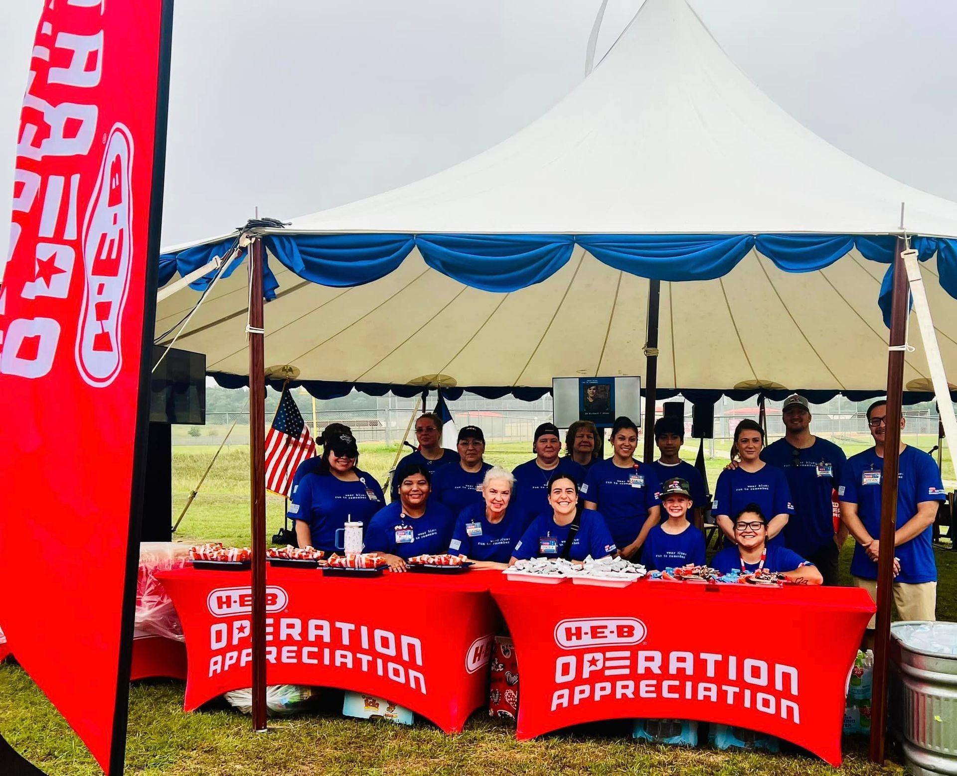 A group of people standing around a table that says operation appreciation