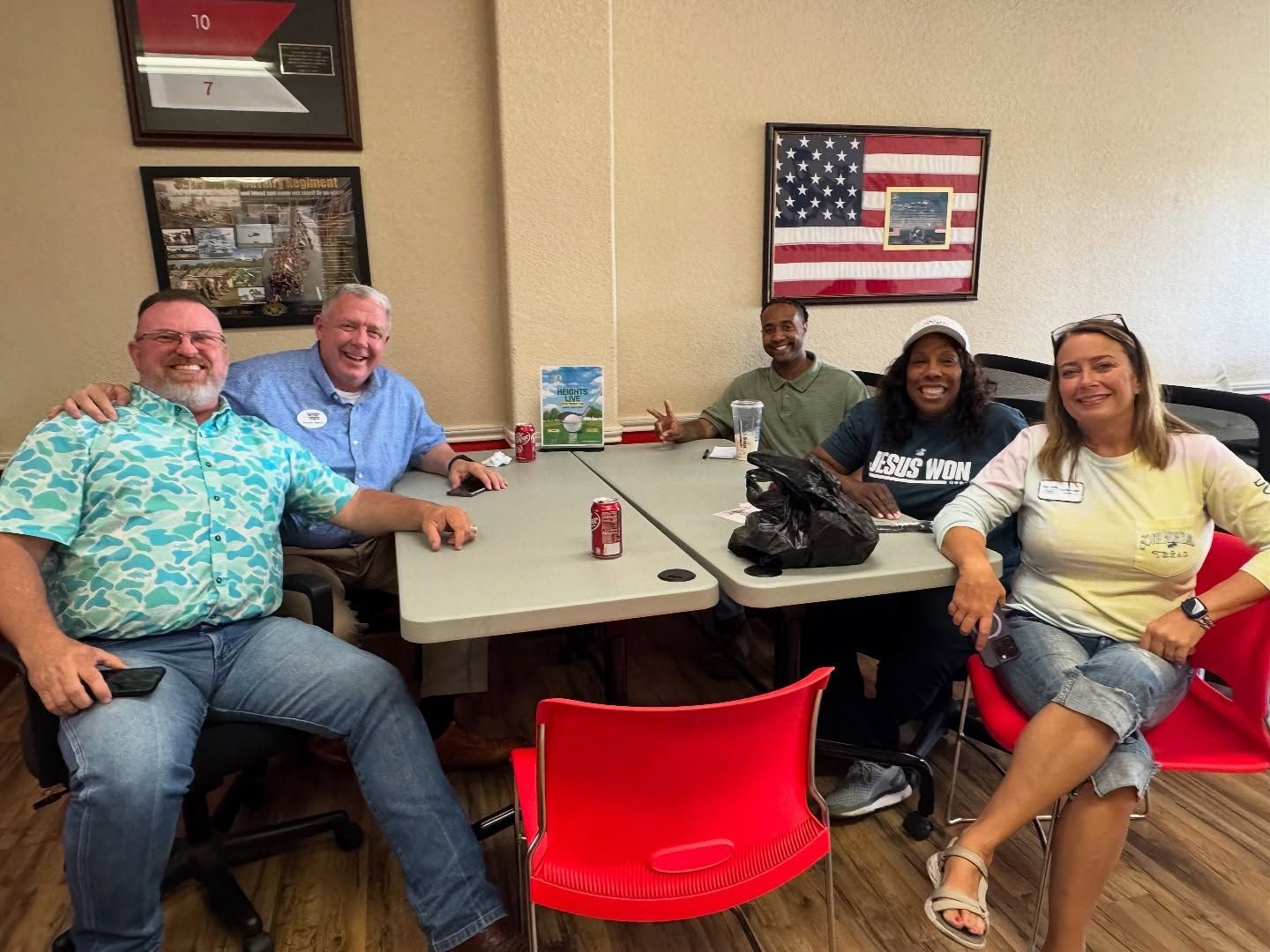 A group of people are sitting around a table in a room.